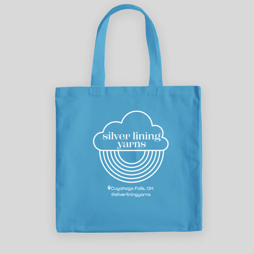 Light blue tote bag with Silver Lining Yarns Logo