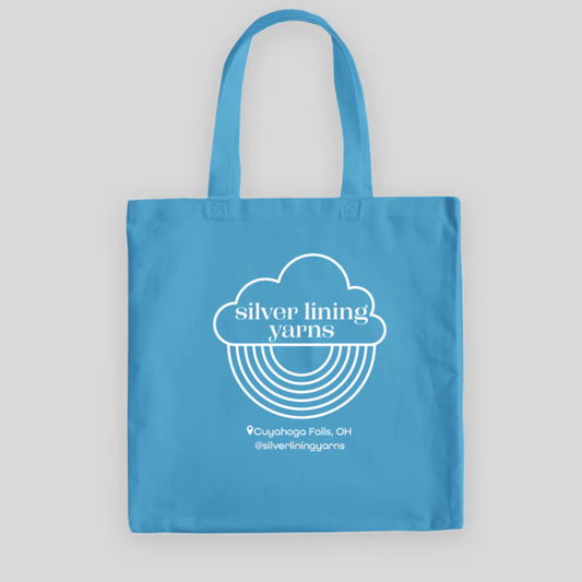 Light blue tote bag with Silver Lining Yarns Logo